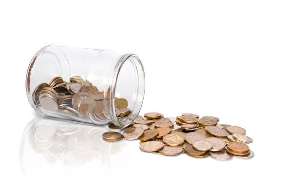 istock bank and scattered coins on a white background 1317440286