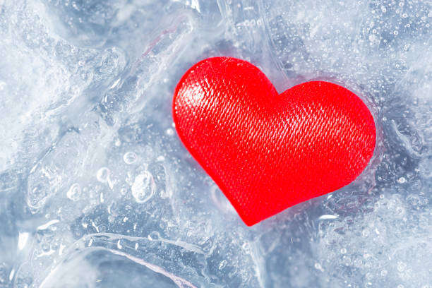 istock Red heart on pieces of melting ice 1317442783