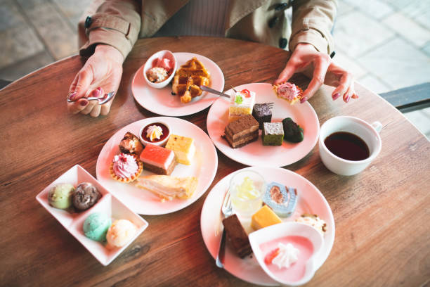 Women eat a lot of sweets Women eat a lot of sweets over eating stock pictures, royalty-free photos & images