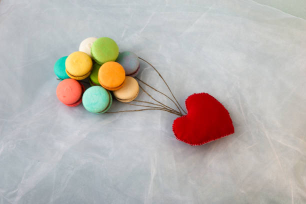 istock Multicolored macarons like balls and a red heart. 1317445162