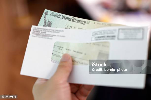 Man Holding A Tax Refund Check Stock Photo - Download Image Now - Tax, Refund, Check - Financial Item