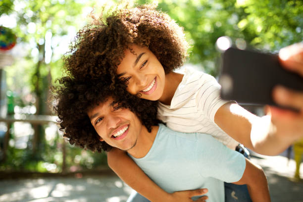 istock happy couple piggyback taking selfie together 1317451418