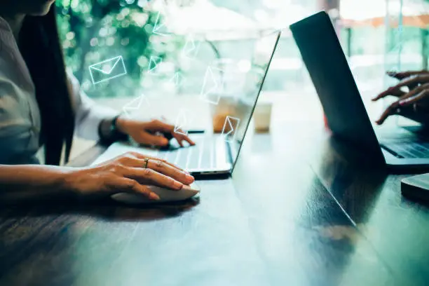 Photo of newsletter concept Hand of a business woman checking message box on digital laptop Vintage tone filter. Close up