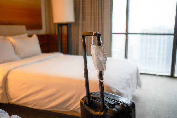 Face Mask and Suitcase in the Hotel Room