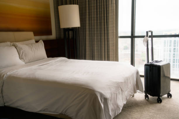 istock Face Mask and Suitcase in the Hotel Room 1317456258