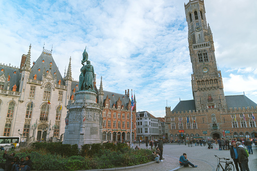 burges/Belgium- Oct 28 2019:crowd tourists walking in Grote Markt square and Belfort tower in Bruges, Belgium.