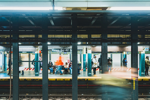 Timesquare Newyork,United States:Dec 2 2019:people waiting and boarding trains at subway station platform in New York city, USA. American city life, or public commuter transportation concept