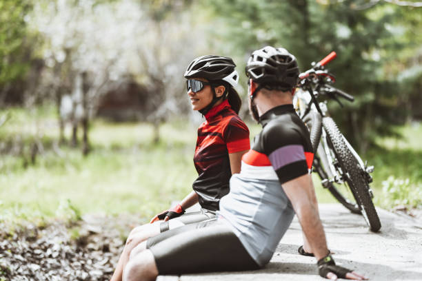 istock Cute Cyclist Couple Relaxing On Bridge Outside 1317459515
