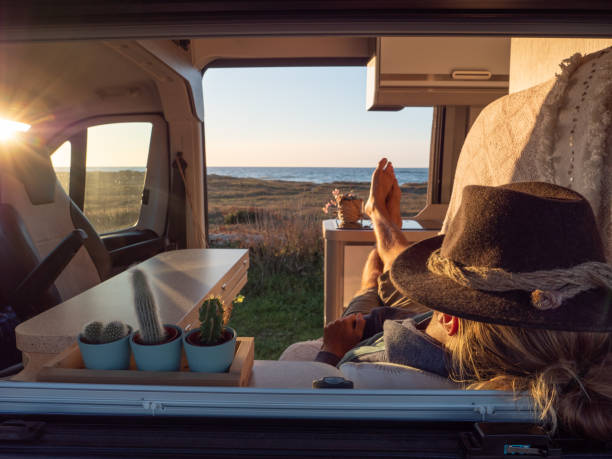 istock Man lying in a van looking at ocean 1317460129