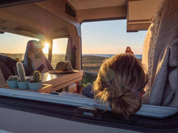 istock Man lying in a van looking at ocean 1317460329