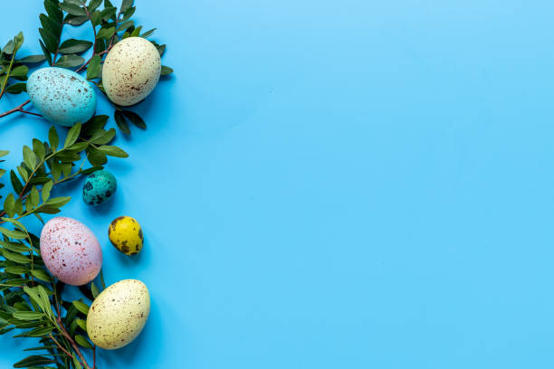 istock Happy Easter with colorful eggs and green branch, top view 1317461883