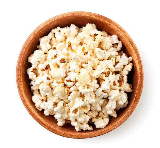 Popcorn in a plate on a white background, isolated. The view from top Popcorn in a plate close-up on a white background, isolated. The view from top popcorn snack bowl isolated stock pictures, royalty-free photos & images