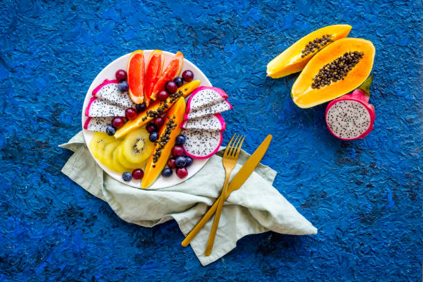 istock Exotic fruit dish with dragon fruit and papaya, top view 1317465486