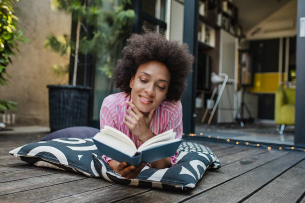 istock Relaxing at home on the balcony and reading a book 1317465736