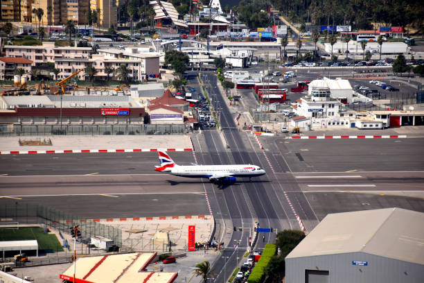 Gibraltar city, Gibraltar - august 21, 2017: british airways airplane go along the gibraltar airport runways with a crossing street