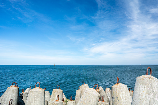 Concrete breakwater on the end of pier.