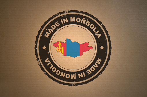 Brown paper with in its middle a retro style stamp Made in Mongolia include the map and flag of Mongolia.