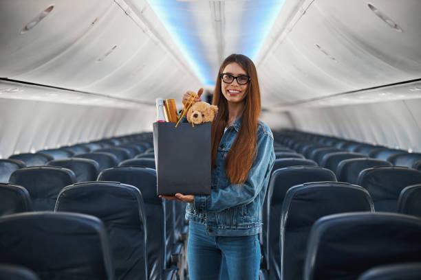 istock Smiling passenger holding shopping bag with presents 1317468137