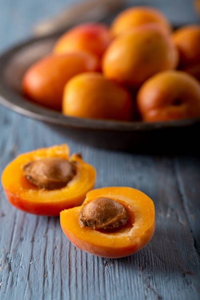 istock Fresh apricots on blue background. Close up. 1317468876
