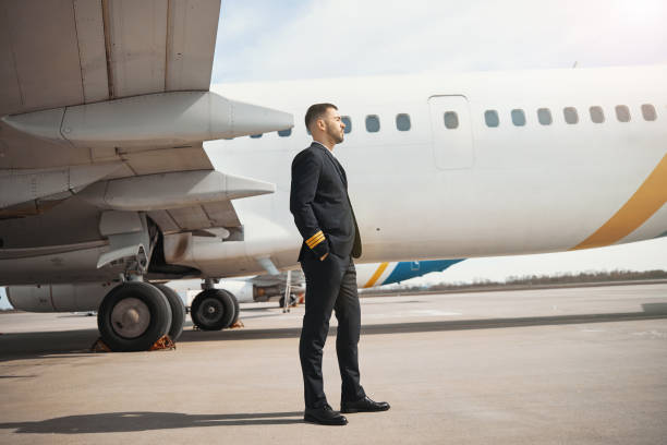 istock Airplane pilot enjoying sunshine near plane wing 1317469166