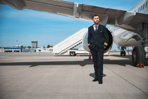 istock Official pilot is staying before plane turbine 1317469191