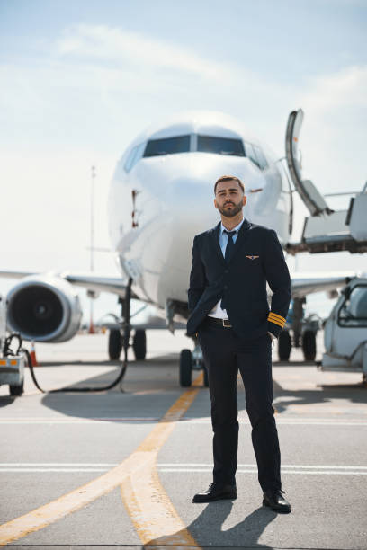 istock Experienced pilot is posing near passenger plane 1317469195