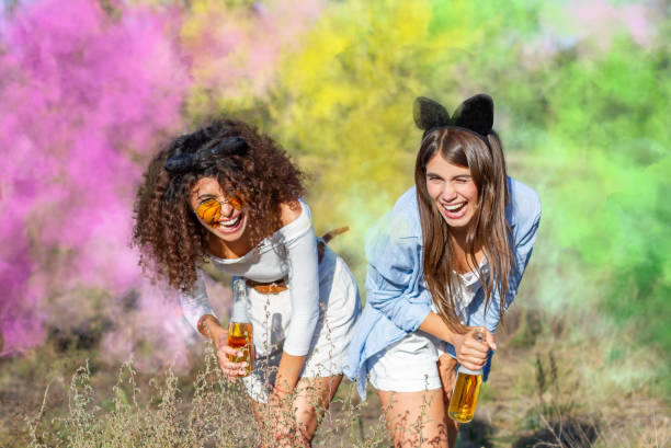 istock Happy friends having fun in the park with multicolored smoke bombs 1317470507