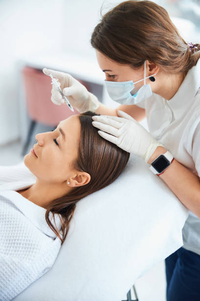istock Woman getting an injection into the forehead 1317471819