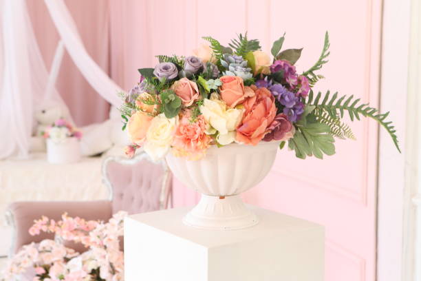 Artificial bouquet of flowers in the interior of a vintage room stock photo