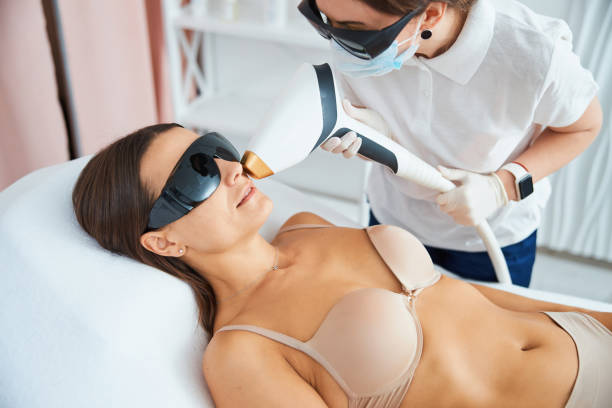 istock Calm patient undergoing a laser hair removal on her face 1317472062