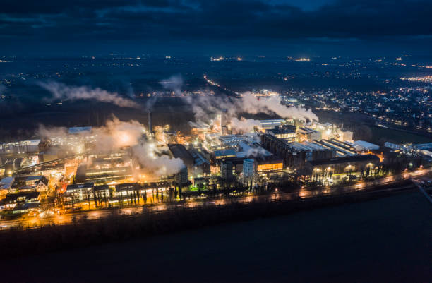 Aerial view of chemical industry producing special products based on aluminum hydroxide and Alumina for the Plastics industry, Paper industry and Paint manufacturers. Factory is illuminated at dawn.