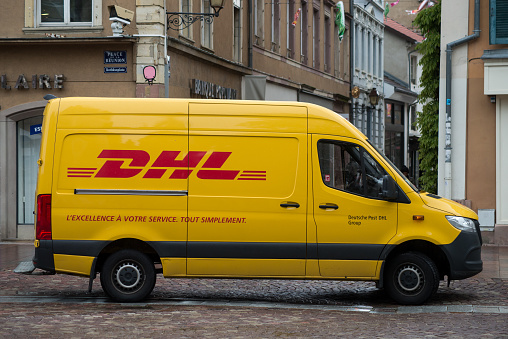 Mulhouse - France - 11 May 2021 - Profile view of DHL truck parked in the street