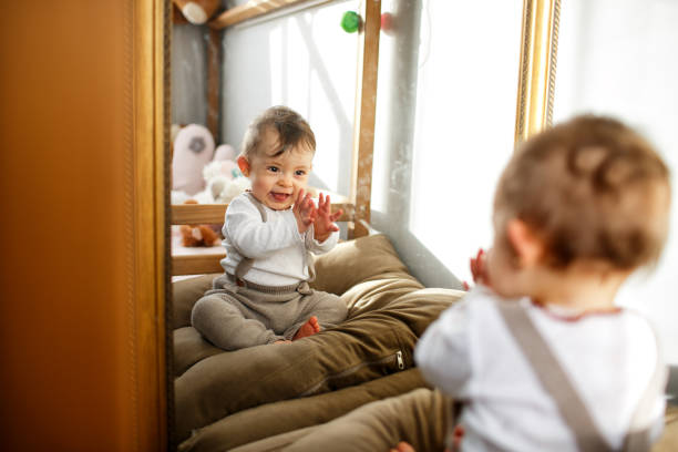 istock Baby girl playing with the mirror 1317476437