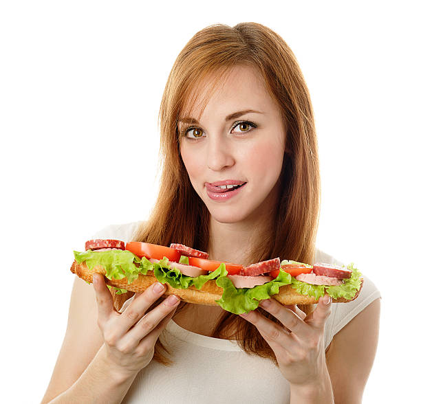 istock Young woman eating fast food 131747710