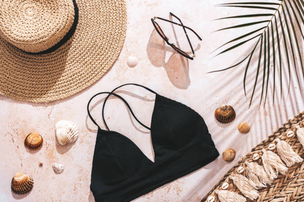 istock Travel flat lay with bikini, beach accessories, straw hat and shadows. 1317478626