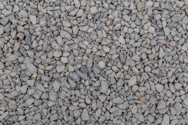 istock Dry white limestone ballast flat full frame background. Small gray dusty broken macadam stones texture. 1317480382