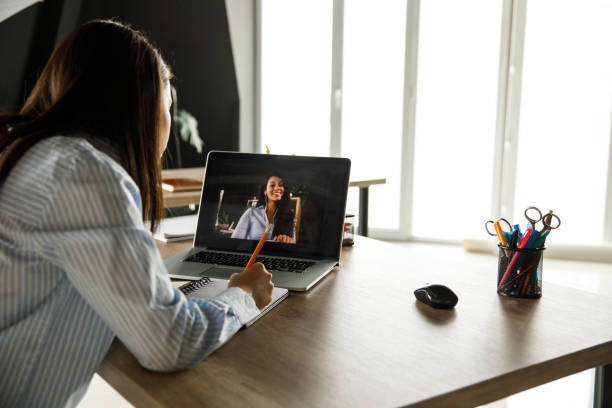 istock Writing plans for future projects during video conference call with a coworker 1317481723