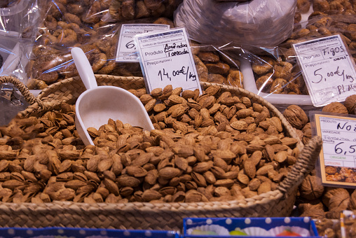 Close up view of a bunch of almond nuts on sale at a market.