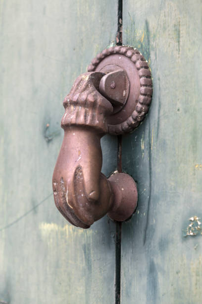istock Old rusty door knocker in shape of a hand. Madeira 1317487176
