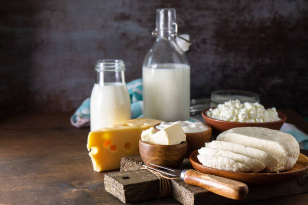 istock Set of different dairy organic products (milk, sour cream, cottage cheese, yogurt and butter) on a rustic wooden countertop. Copy space. 1317488156