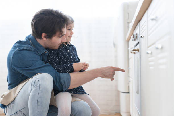 istock Young handsome father cooking baking with his little daughter, preparing meal for dinner, family celebration, spending time together. Parenhood and fatherhood. Happy father`s day! 1317493779