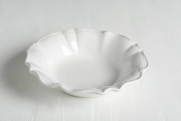 istock Empty ceramic bowl on white wooden table, closeup 1317494616