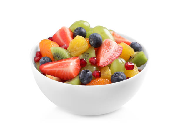 istock Fresh delicious fruit salad in bowl on white background 1317494621