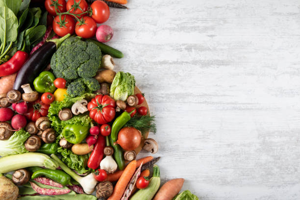 istock Fresh and Raw Vegetables on Wooden Kitchen Table 1317495471