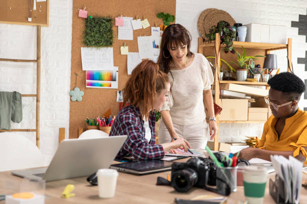 istock Creative women discussing project ideas at the graphic design studio 1317495515