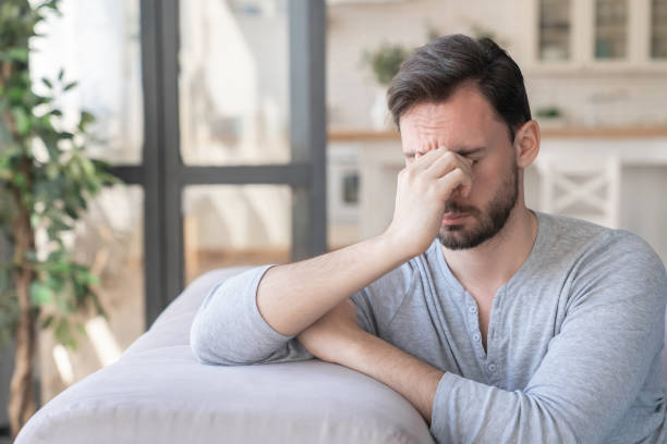 istock Tired stressed sad bored young caucasian man relaxing after work, family relationship problems, emotional stress, depression. Negative emotions concept 1317495585