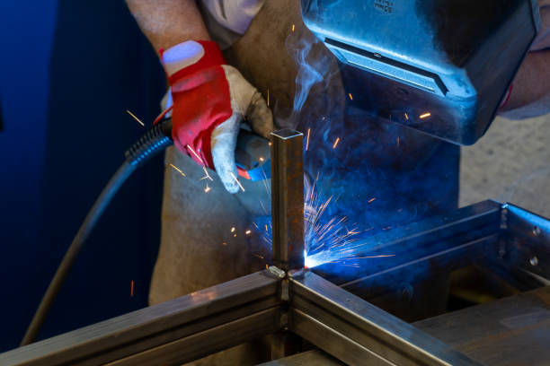 istock Man welding steel frames in a forgery and metal works workshop 1317495810