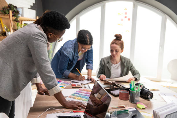 istock Group of creative women working on a project together at the graphic design studio 1317496675