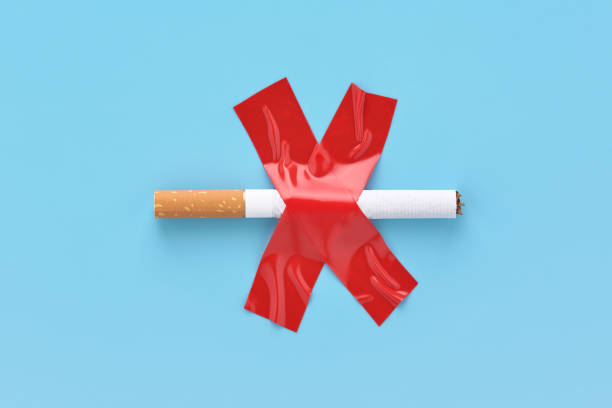 crossed out cigarette, glued with red adhesive tape, no smoking concept. - quitting imagens e fotografias de stock