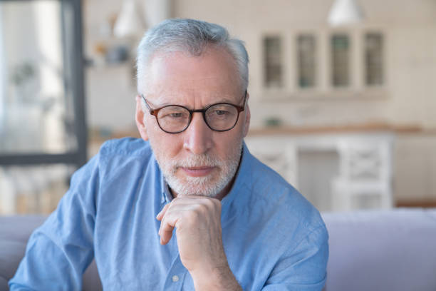 istock Serious pensive thoughtful caucasian old senior elderly man granfather thinking about his grandchildren, left alone at home. Health problems, paying bills concept 1317497177